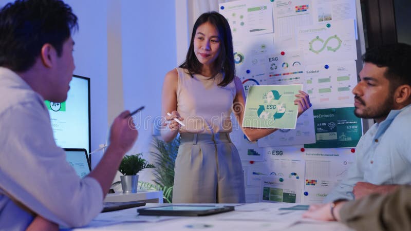 Diversity team presentation about ESG sustainability business goals sdgs in green office at night stock images