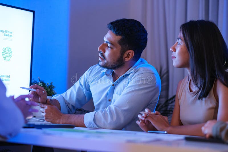 Diversity team presentation about ESG sustainability business goals sdgs in green office at night royalty free stock images
