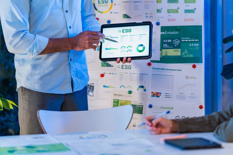Diversity team presentation about ESG sustainability business goals sdgs in green office at night stock photography