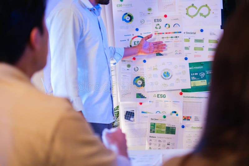 Diversity team presentation about ESG sustainability business goals sdgs in green office at night royalty free stock photography
