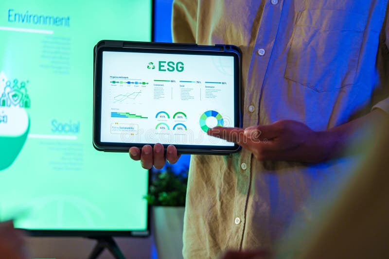 Diversity team presentation about ESG sustainability business goals sdgs in green office at night royalty free stock photography