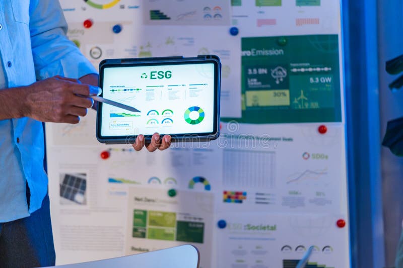 Diversity team presentation about ESG sustainability business goals sdgs in green office at night stock photography