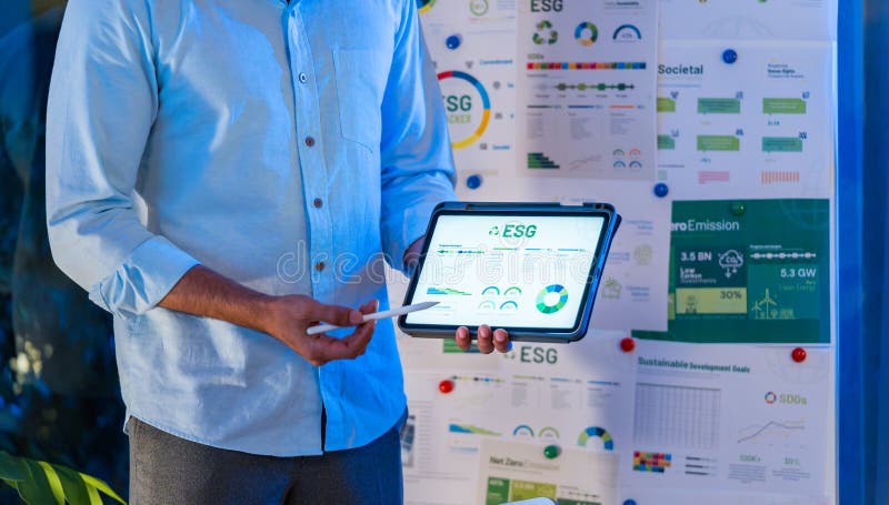 Diversity team presentation about ESG sustainability business goals sdgs in green office at night royalty free stock photography