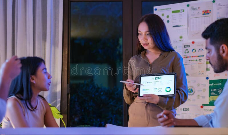 Diversity team presentation about ESG sustainability business goals sdgs in green office at night stock images