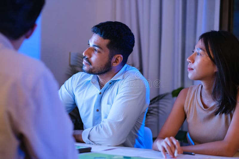 Diversity team presentation about ESG sustainability business goals sdgs in green office at night royalty free stock image