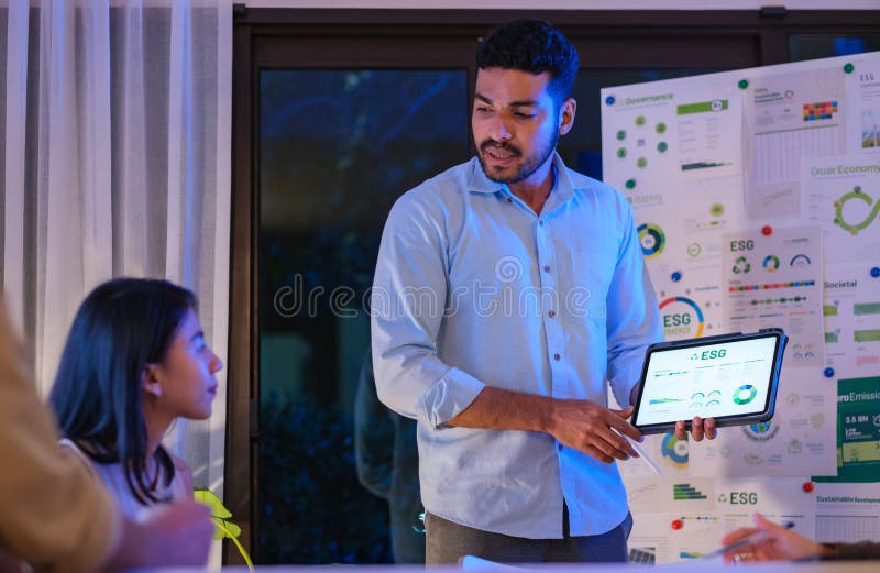 Diversity team presentation about ESG sustainability business goals sdgs in green office at night stock image