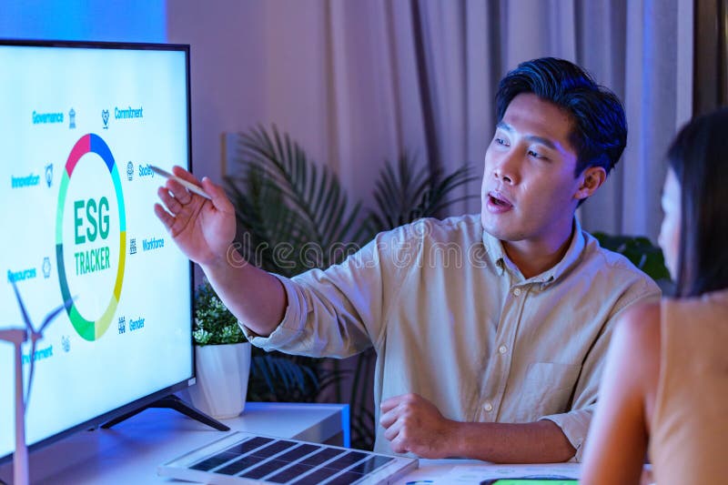 Diversity team presentation about ESG sustainability business goals sdgs in green office at night stock image