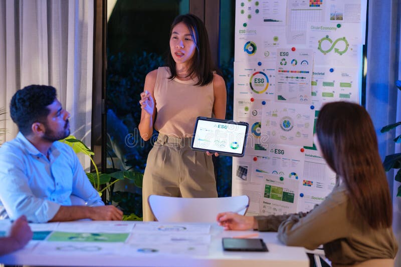 Diversity team presentation about ESG sustainability business goals sdgs in green office at night stock images