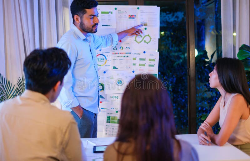 Diversity team presentation about ESG sustainability business goals sdgs in green office at night stock photos