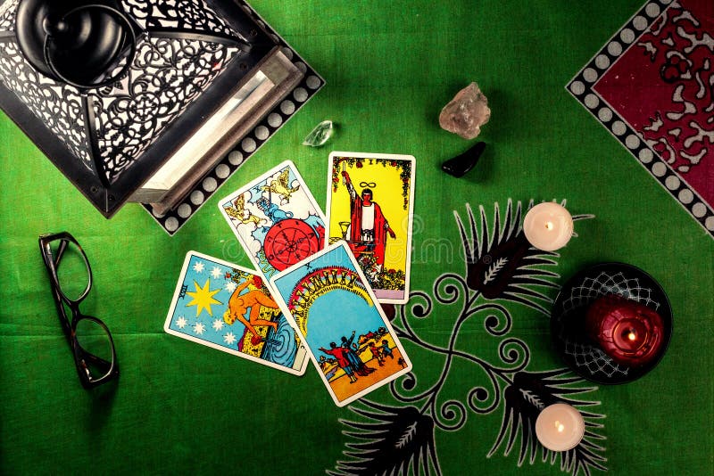 Divination by tarot cards. On a background of a green tablecloth with burning candles royalty free stock photos Divination by tarot cards. On a background of a green tablecloth with burning candles royalty free stock photos