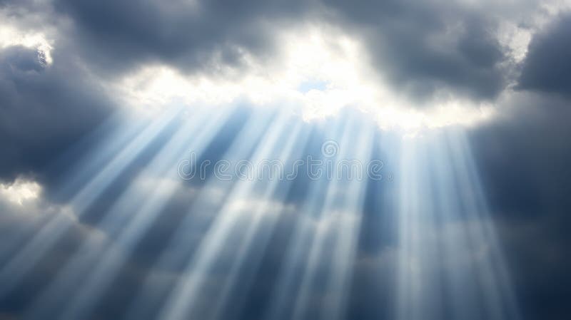 Divine Light Rays piercing through dramatic clouds creating a celestial spectacle stock image