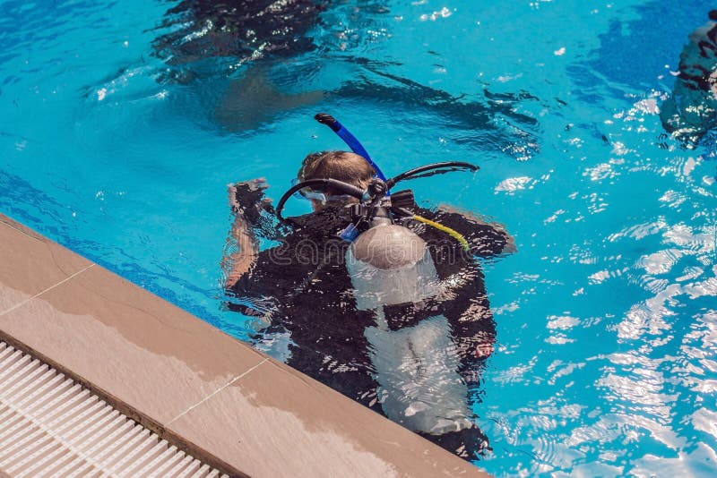 Diving Instructor and Students. Instructor Teaches Students To Dive