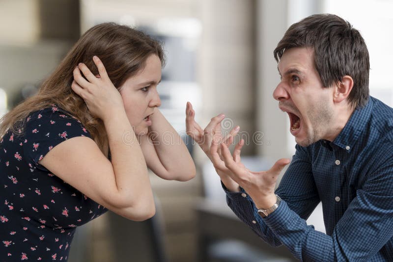 Divorce concept. Young angry couple arguing and shouting. Divorce concept. Young angry couple arguing and shouting