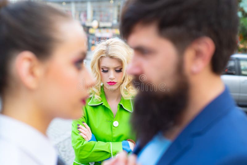 Divorce reason. Infidelity. Disloyal man walking with his girlfriend and looking amazed at another seductive girl