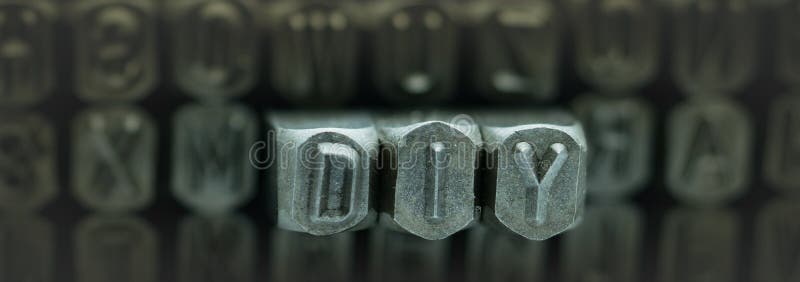 DIY spelled from metal stamp alphabet punch, DIY words stand for Do It Yourself concept. DIY spelled from metal stamp alphabet punch, DIY words stand for Do It Yourself concept