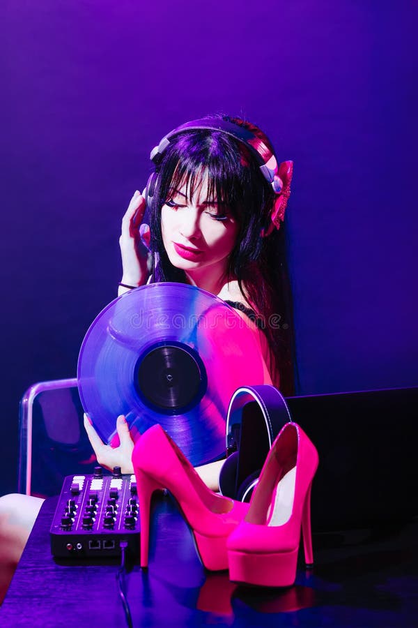 Dj headphone equipment disco girl party retro vintage ultraviolet mixer shoes young woman vinyl glamor valentine`s day plastic royalty free stock images Dj headphone equipment disco girl party retro vintage ultraviolet mixer shoes young woman vinyl glamor valentine`s day plastic royalty free stock images