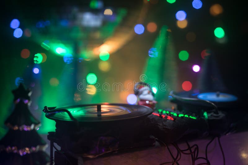 Dj Mixer with Headphones on Dark Nightclub Background with Christmas Tree  New Year Eve. Close Up View of New Year Elements on a Dj Stock Image -  Image of disco, headphones: 169741801