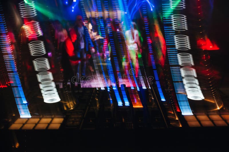 DJ Mixer in a with Glowing Colored Lights from Controllers