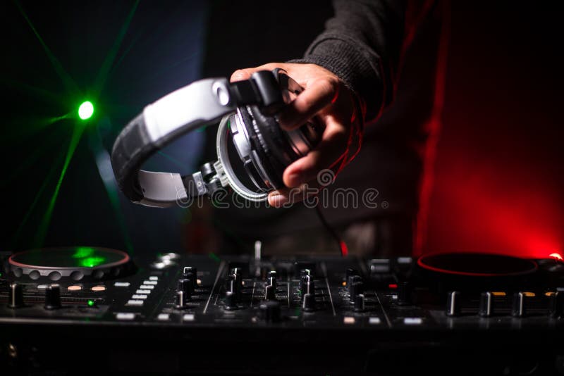 DJ Spinning, Mixing, and Scratching in a Night Club, Hands of Dj Tweak Various Track Controls on