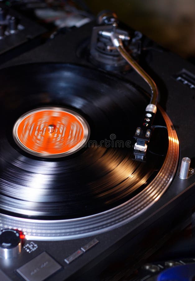 Dj turntables needle cartridge on black vinyl record with music. Close up, focus on turntable and audio disc record royalty free stock photo Dj turntables needle cartridge on black vinyl record with music. Close up, focus on turntable and audio disc record royalty free stock photo