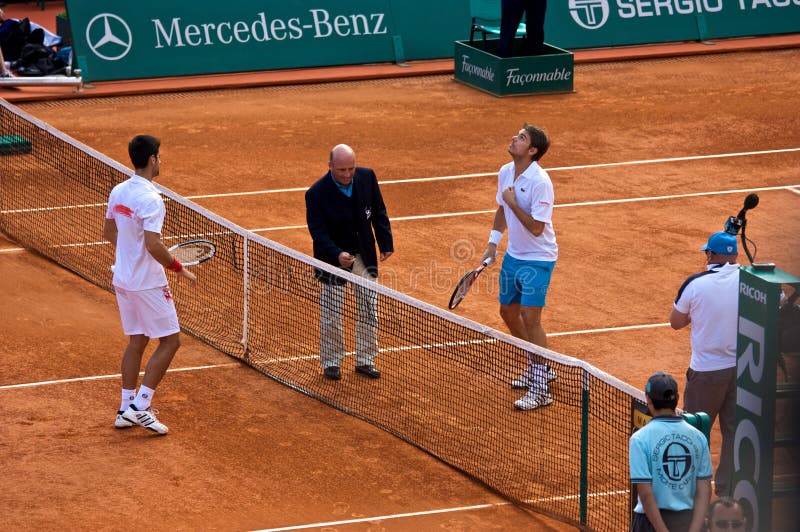 Djokovic Montecarlo Rolex Master 1. Djokovic playing tennis at Montecarlo Rolex Master 2010 stock image Djokovic Montecarlo Rolex Master 1. Djokovic playing tennis at Montecarlo Rolex Master 2010 stock image