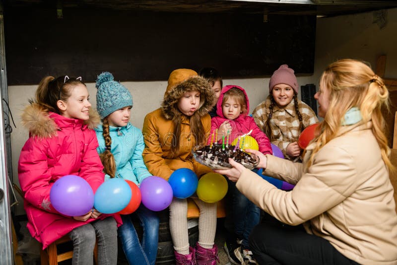 Dnipro, Ukraine - March 21, 2022: Children`s birthday party in basement during an air raid alert