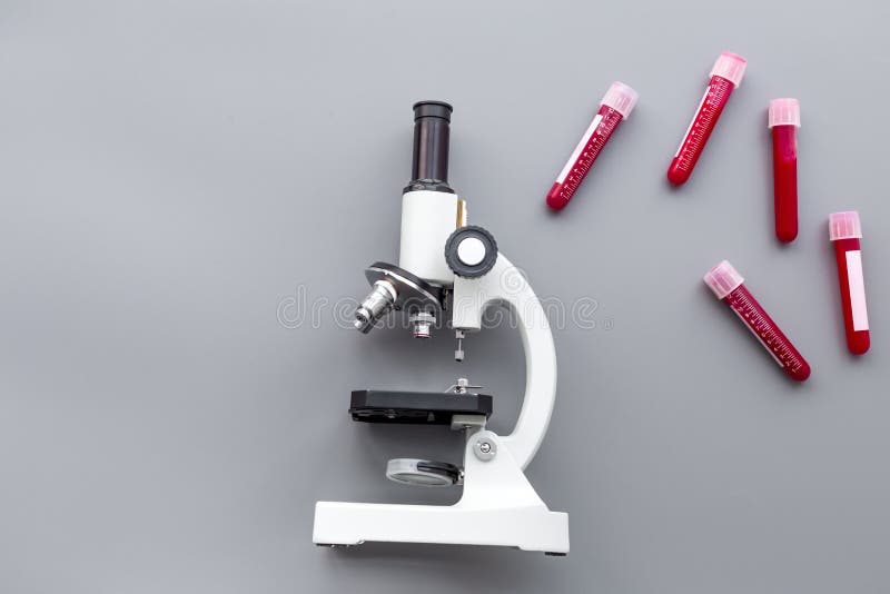 Do Blood Test in Laboratory. Analysis. Blood Samples in Test Tubes Near Microscope on Grey