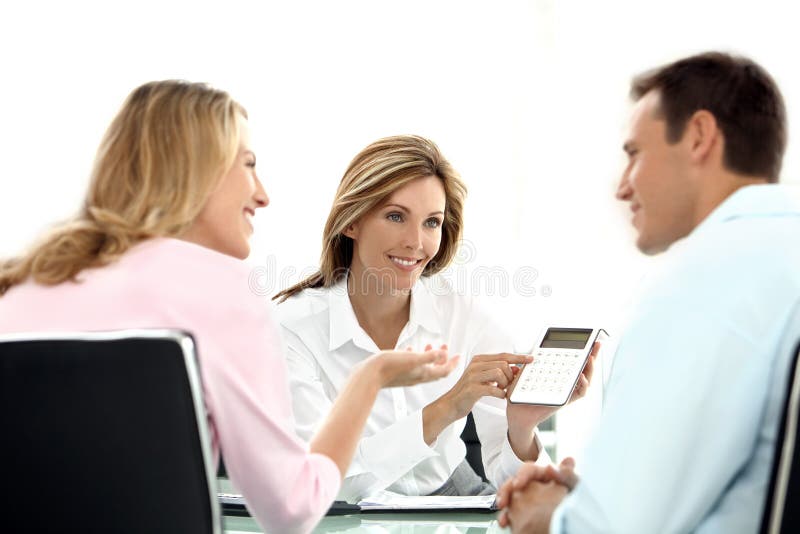 Young Couple dealing with a financial adviser holding a calculator at the bank. Young Couple dealing with a financial adviser holding a calculator at the bank