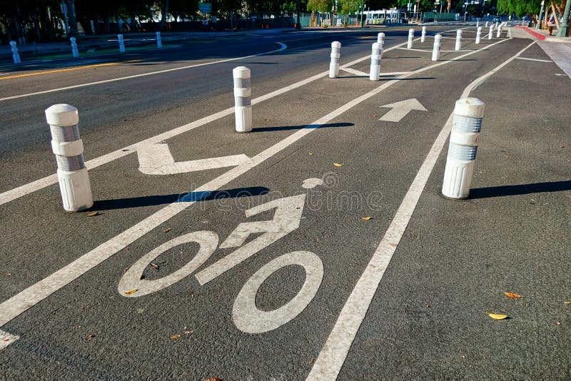 Lines, lanes, and symbols mark the designation as the bollards make sure the biker is safe and secure from vehicles attempting to cross over. Lines, lanes, and symbols mark the designation as the bollards make sure the biker is safe and secure from vehicles attempting to cross over.