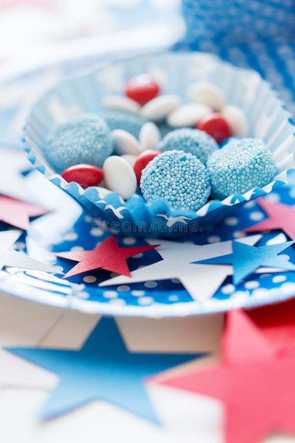 American independence day, celebration, patriotism and holidays concept - close up of glazed sweet candies with stars decoration at 4th july theme party. American independence day, celebration, patriotism and holidays concept - close up of glazed sweet candies with stars decoration at 4th july theme party