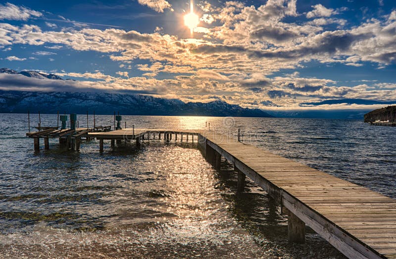 Dock on Okanagan Lake Kelowna British Columbia Canada in the winter with setting sun. Dock on Okanagan Lake Kelowna British Columbia Canada in the winter with setting sun