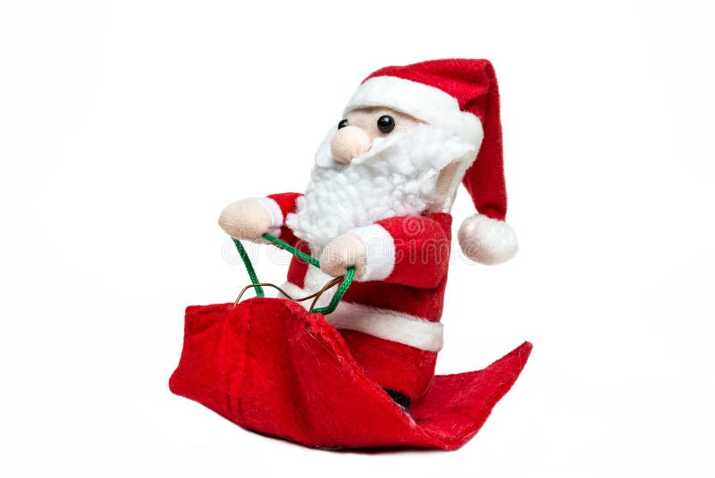 Docka Santa Claus på släden på vit bakgrund glad jul sida royaltyfria bilder Docka Santa Claus på släden på vit bakgrund glad jul sida royaltyfria bilder