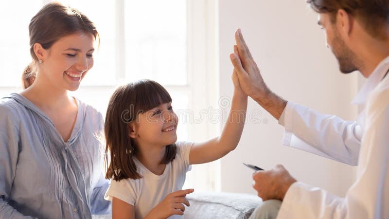 Friendly pediatrician doctor giving high five to little girl patient, welcoming, greeting smiling mother and cute daughter at consultation, celebrating good medical checkup results, medical insurance. Friendly pediatrician doctor giving high five to little girl patient, welcoming, greeting smiling mother and cute daughter at consultation, celebrating good medical checkup results, medical insurance