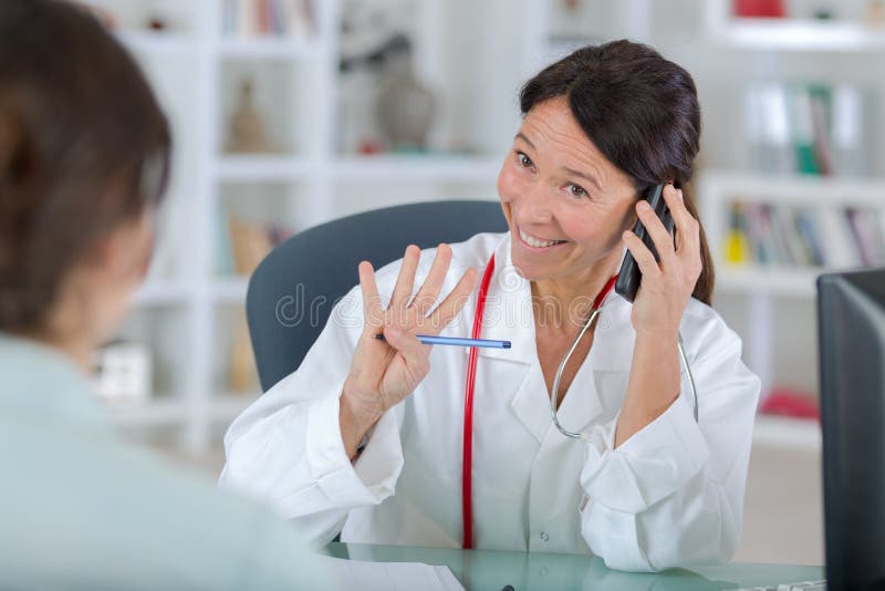 Doctor answering a call royalty free stock photo Doctor answering a call royalty free stock photo