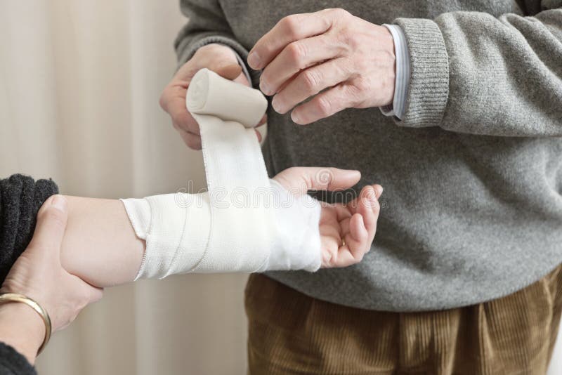Doctor Applying Bandage On Injured Hand stock photo