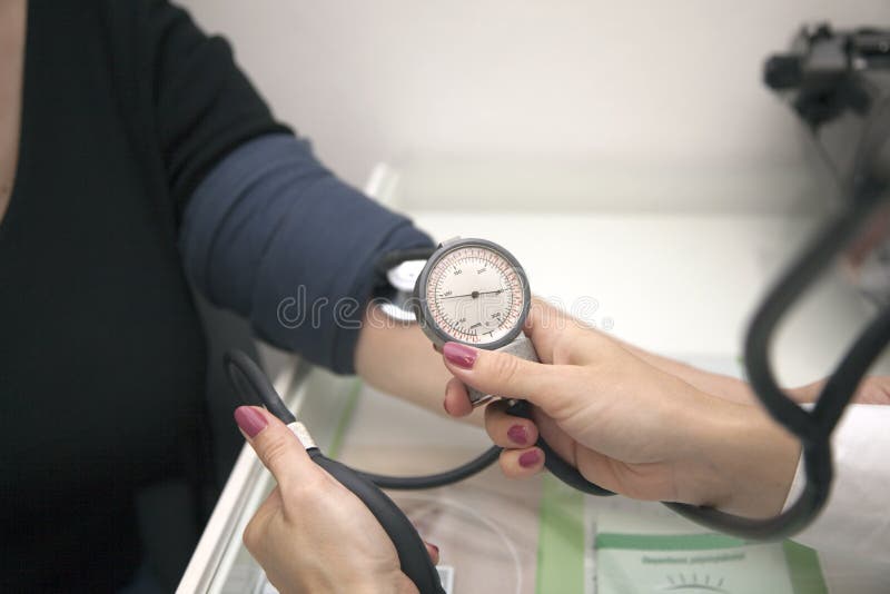 Doctor checking blood pressure