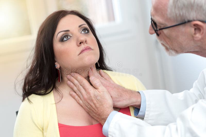 Doctor checking thyroid, light effect royalty free stock photography