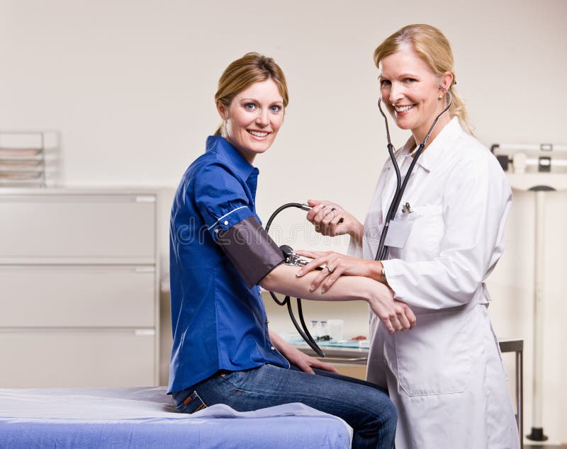 Doctor Checking Woman Blood Pressure Stock Photo Image of care, coat