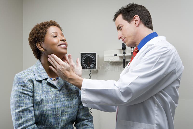 Doctor checking womans throat royalty free stock image Doctor checking womans throat royalty free stock image