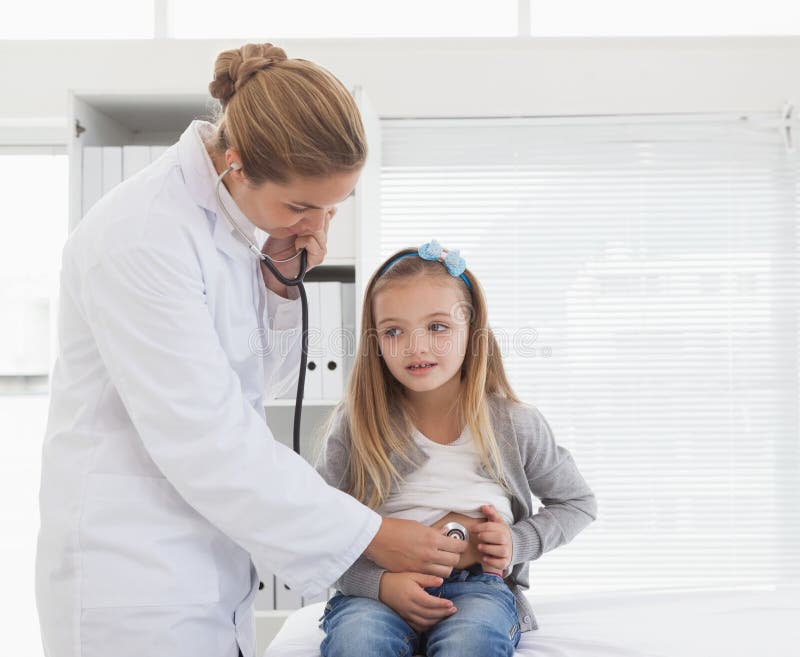 Doctor checking a young patients stomach stock photos Doctor checking a young patients stomach stock photos