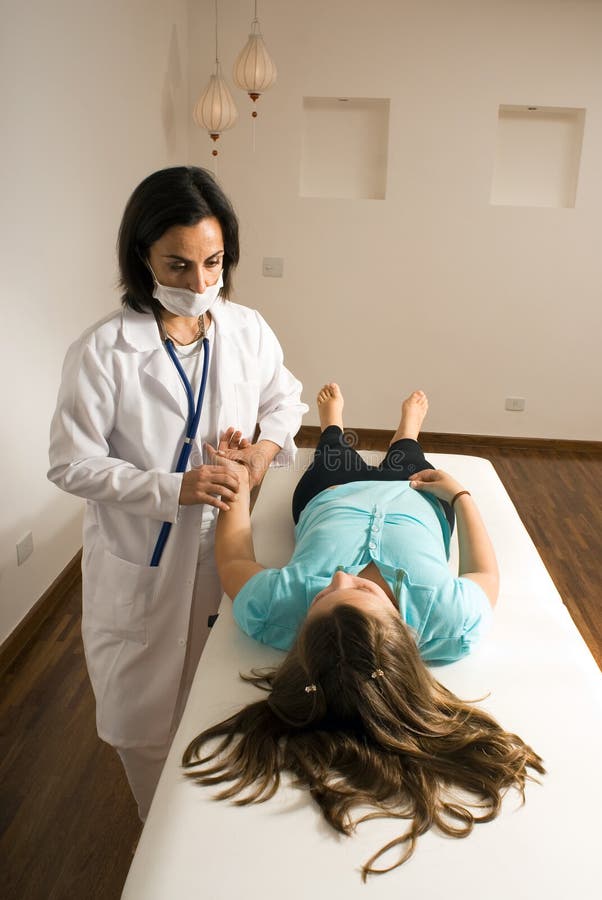 A doctor checks a patient s pulse-Vertical picture