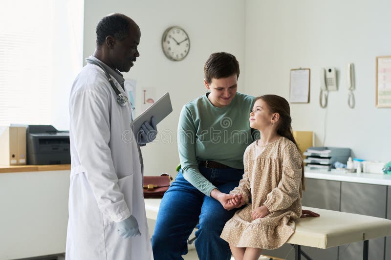 Doctor Consulting Patient in Medical Examination Room stock photography