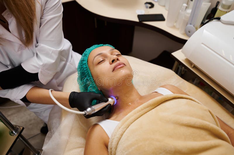 Doctor Cosmetologist Performs Massage with Microcurrents Stock Photo