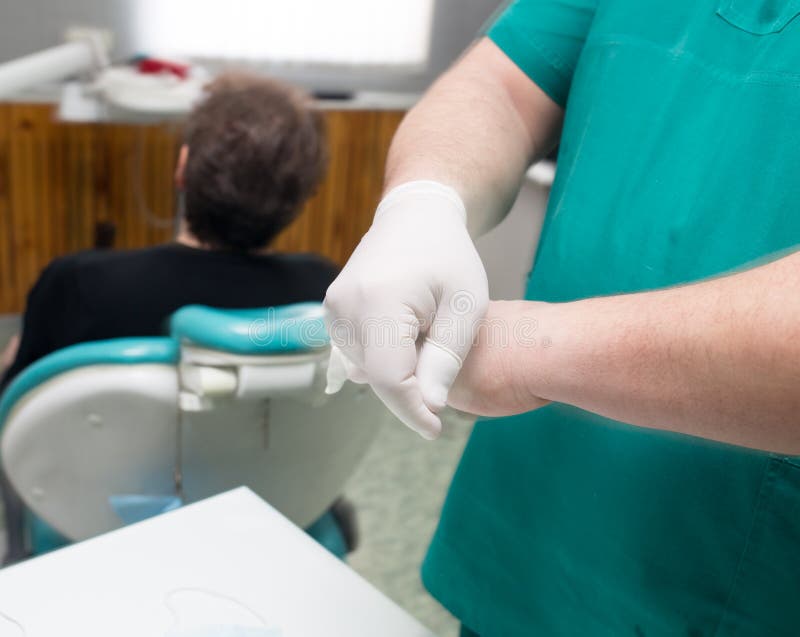 Doctor Dentist Puts on White Gloves in the Clinic Stock Image Image