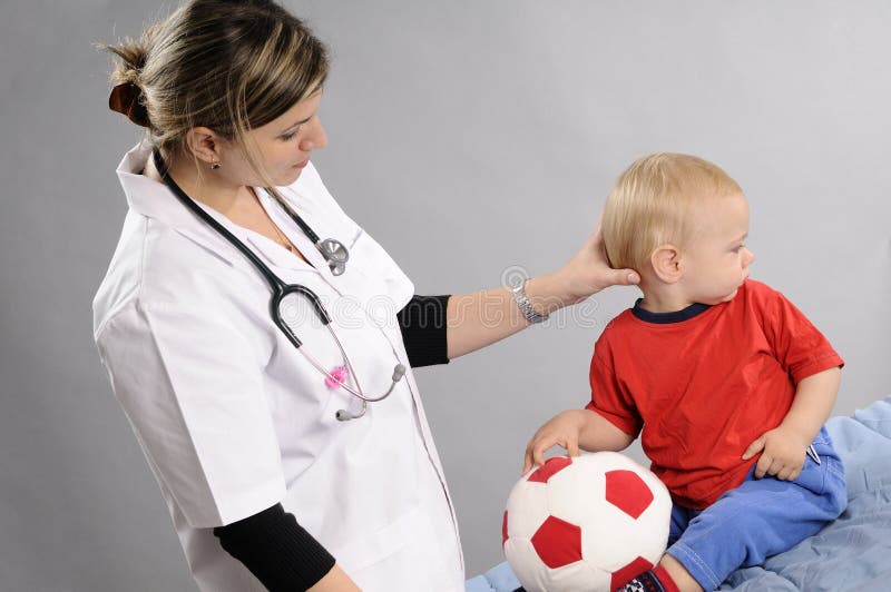 Doctor examining baby boy