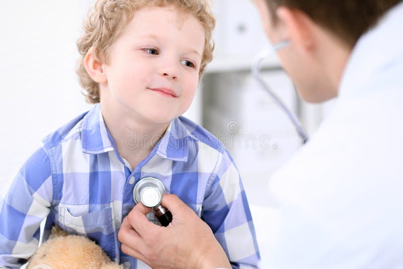 Doctor examining a child patient by stethoscope stock photos Doctor examining a child patient by stethoscope stock photos
