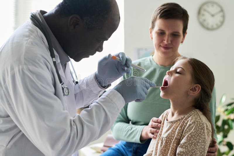Doctor Conducting Medical Examination of Child stock images