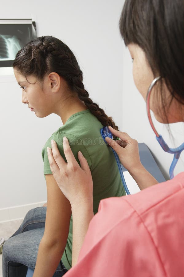 Doctor Examining Girl Using Stetho