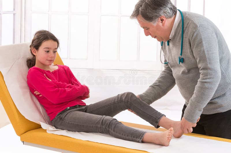 Doctor Examining The Injured Knee Of A Teen Girl Stock Photo Image Of