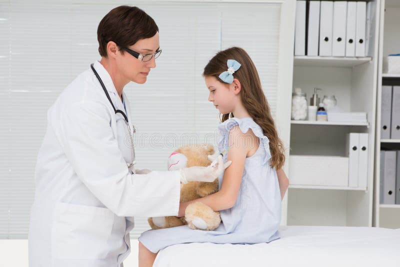 Doctor examining little girl. 
